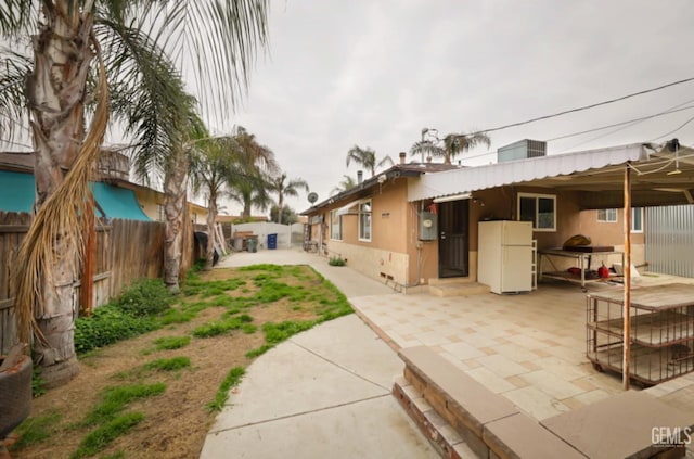 back of property with a patio