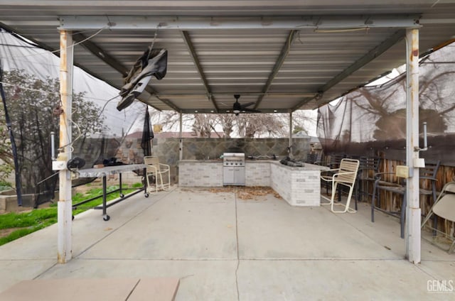 view of patio featuring an outdoor kitchen, an outdoor bar, and ceiling fan