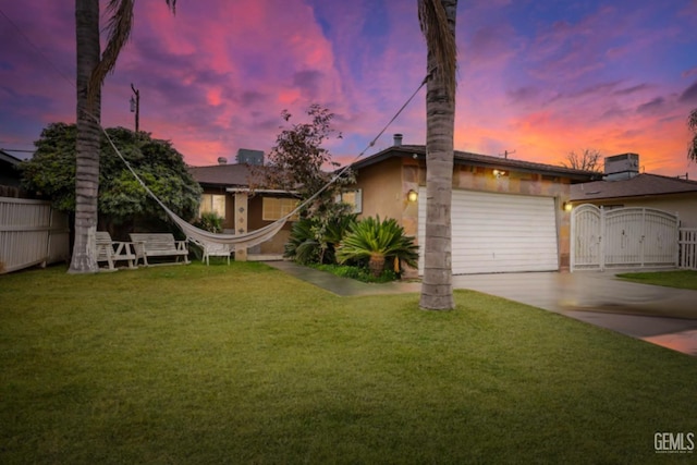 view of front facade featuring a garage and a yard