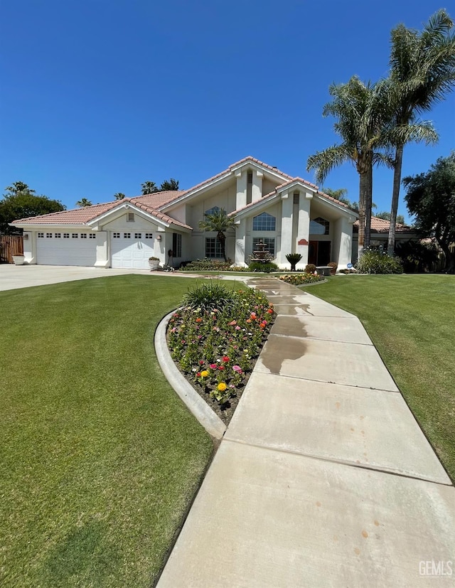 13400 Pergola Ave, Bakersfield, CA 93314 - view of front facade featuring a garage, stucco siding, a front yard, a tile roof, and driveway