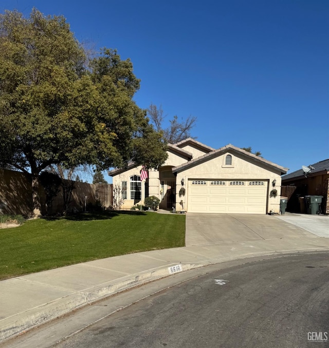 view of front facade featuring a front lawn and a garage