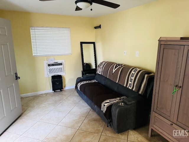 living area featuring a ceiling fan, a wall mounted air conditioner, baseboards, and light tile patterned floors