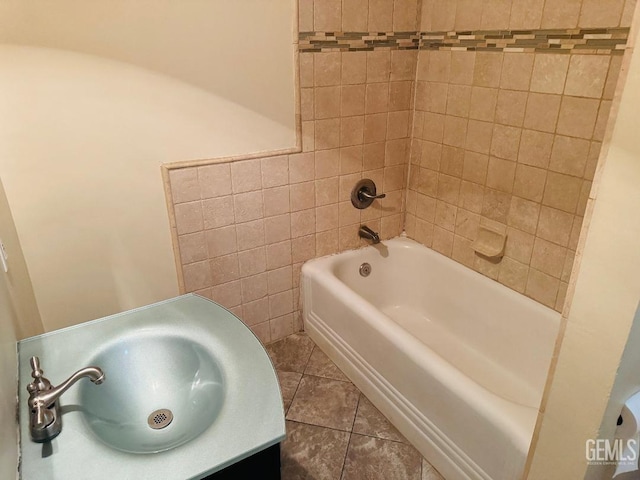 bathroom with tile patterned flooring, tile walls, and a sink