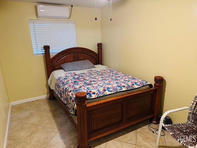 bedroom featuring baseboards, light tile patterned flooring, and a wall mounted AC