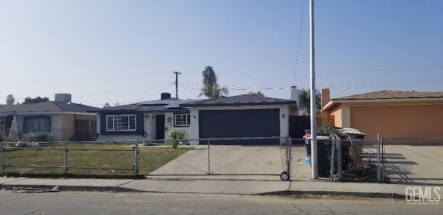 single story home with solar panels and a garage