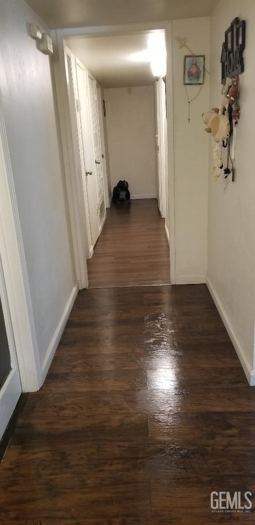 corridor featuring dark hardwood / wood-style floors