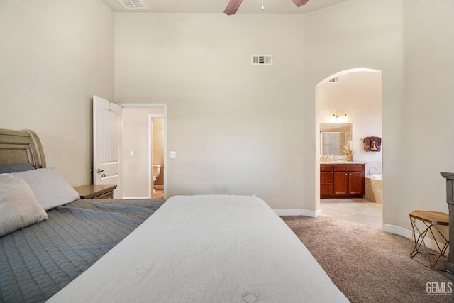 6207 Provincetown Ave, Bakersfield, CA 93313 - bedroom featuring a high ceiling, light colored carpet, ensuite bathroom, arched walkways, and a ceiling fan