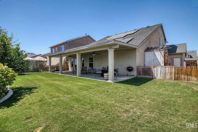 6207 Provincetown Ave, Bakersfield, CA 93313 - back of house with a ceiling fan, a fenced backyard, a patio, stucco siding, and roof mounted solar panels