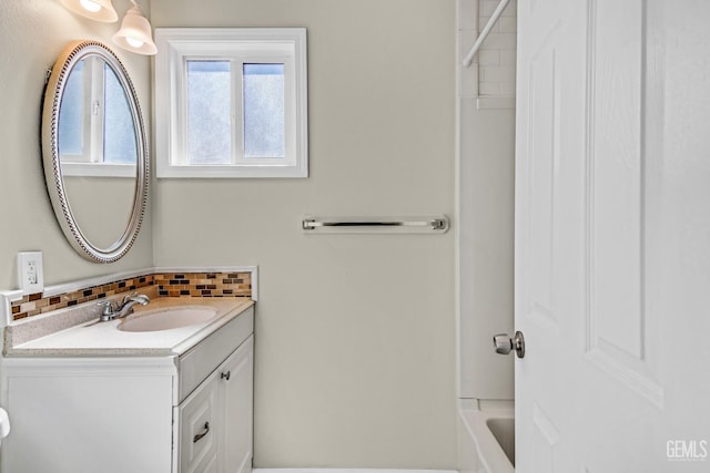 bathroom with vanity, tasteful backsplash, and shower / tub combination