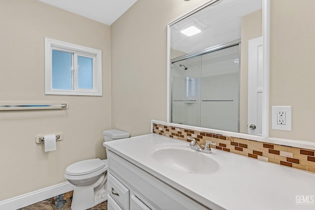 bathroom featuring vanity, toilet, backsplash, and walk in shower