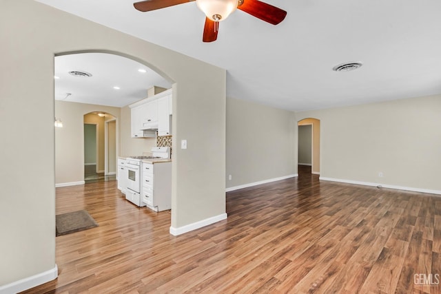 unfurnished living room featuring light hardwood / wood-style floors and ceiling fan