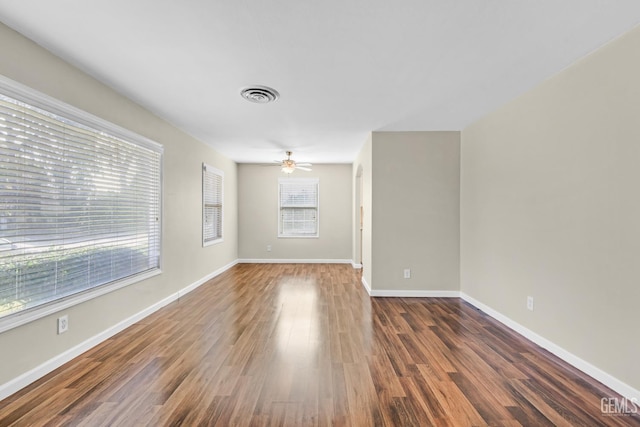 spare room featuring dark wood-type flooring and ceiling fan