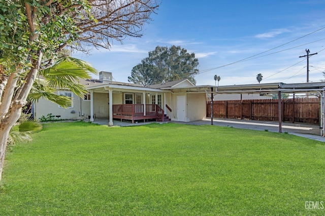 rear view of property with a yard, central air condition unit, and a deck