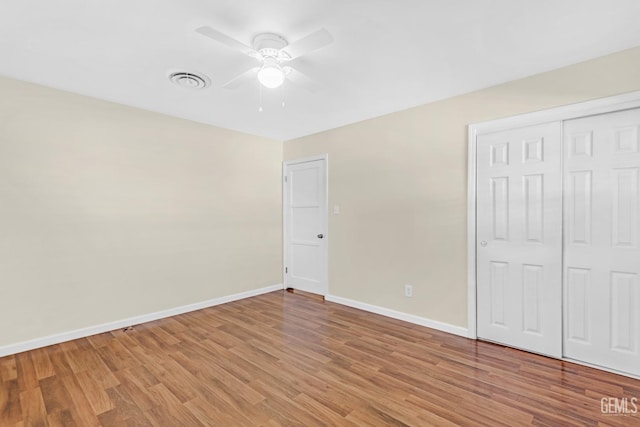 unfurnished bedroom with ceiling fan, light hardwood / wood-style floors, and a closet