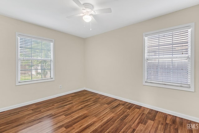 empty room featuring dark hardwood / wood-style floors and ceiling fan