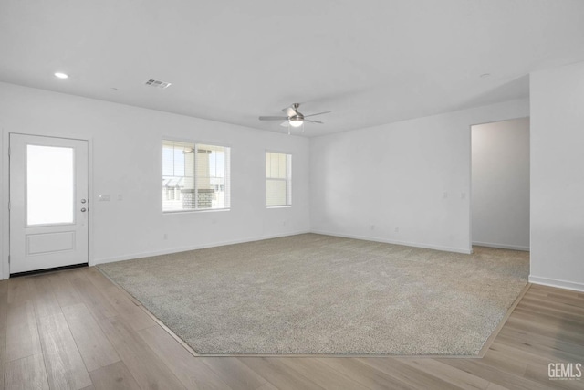 unfurnished living room with recessed lighting, wood finished floors, baseboards, visible vents, and a ceiling fan