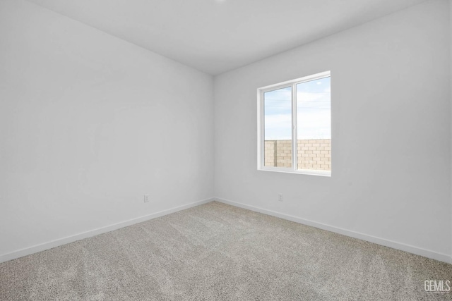 empty room with carpet flooring and baseboards