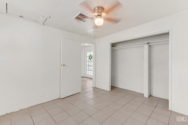 unfurnished bedroom featuring a closet, ceiling fan, and light tile patterned flooring