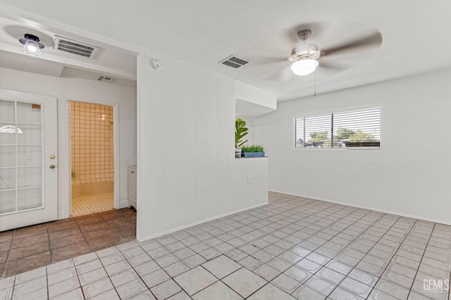 unfurnished room with light tile patterned floors and ceiling fan