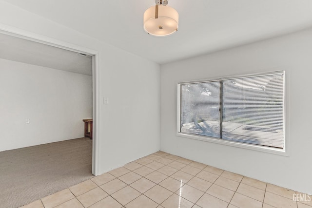 unfurnished room with light colored carpet