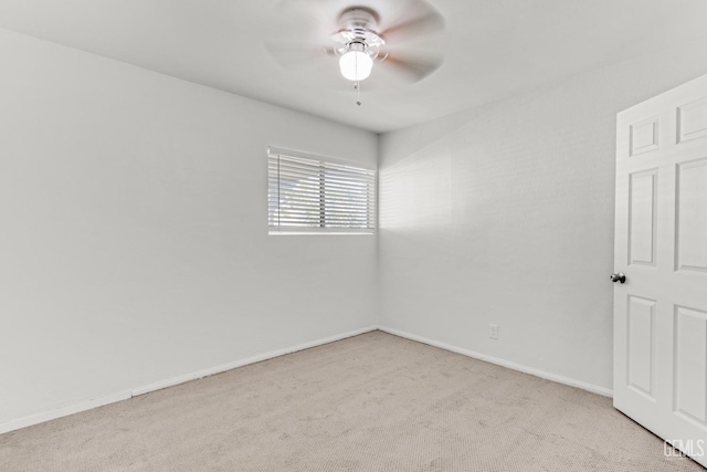 empty room featuring light carpet and ceiling fan