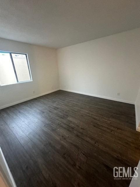 unfurnished room featuring dark hardwood / wood-style floors