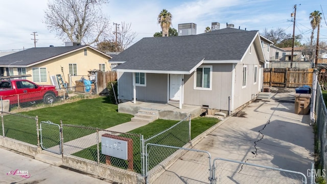 bungalow-style house featuring a fenced front yard, a gate, a front lawn, and a shingled roof