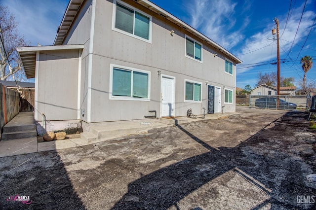 rear view of property with a patio area and a fenced backyard