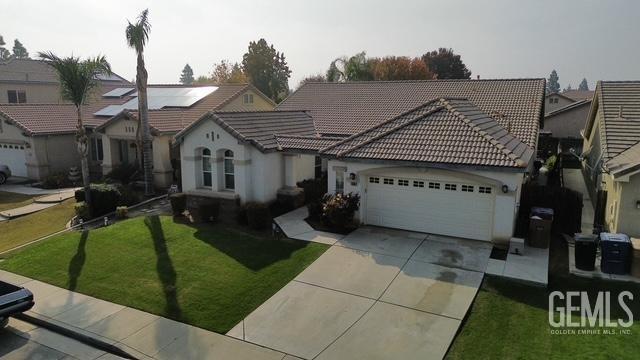 view of front of property with a garage and a front lawn