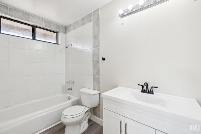 full bathroom with vanity, toilet, wood-type flooring, and tiled shower / bath combo