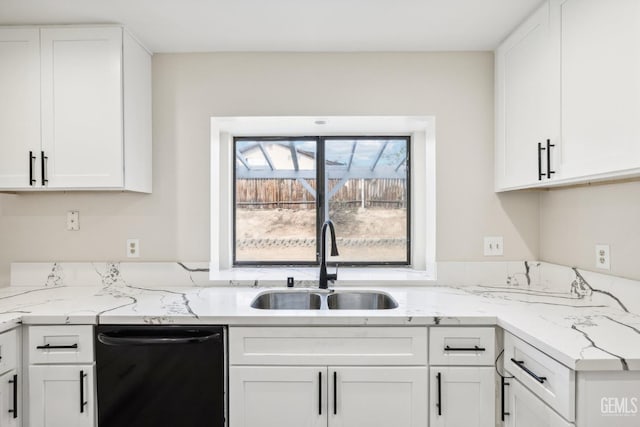 kitchen featuring dishwasher, white cabinets, light stone counters, and sink