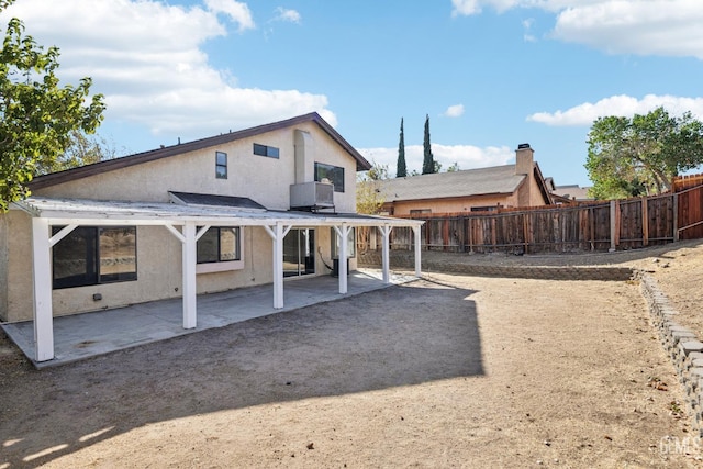 rear view of property featuring a patio area and central air condition unit