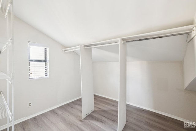 spacious closet featuring wood-type flooring and lofted ceiling