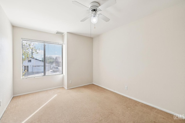 carpeted empty room featuring ceiling fan