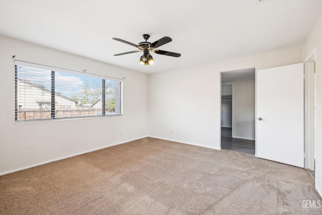 carpeted empty room featuring ceiling fan