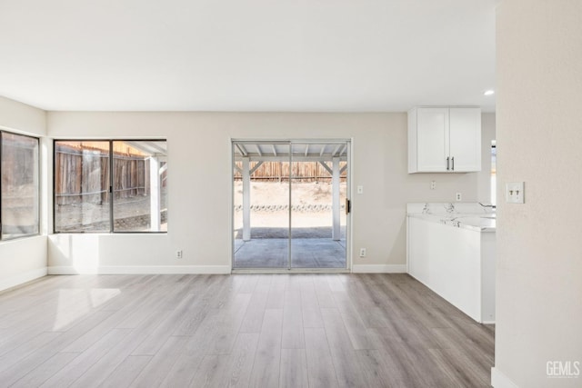 unfurnished living room featuring light hardwood / wood-style floors