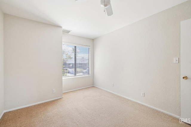 unfurnished room featuring light carpet and ceiling fan