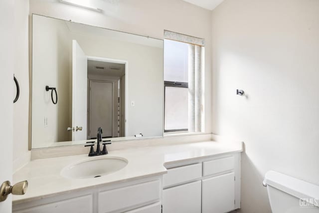 bathroom featuring vanity and toilet