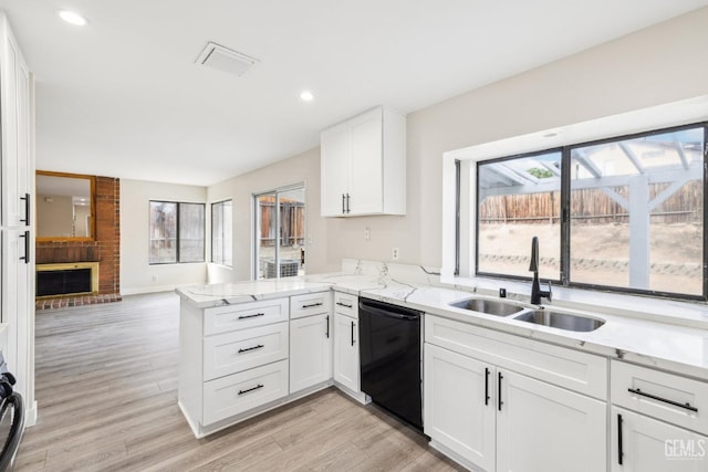 kitchen with kitchen peninsula, sink, dishwasher, light hardwood / wood-style floors, and white cabinetry