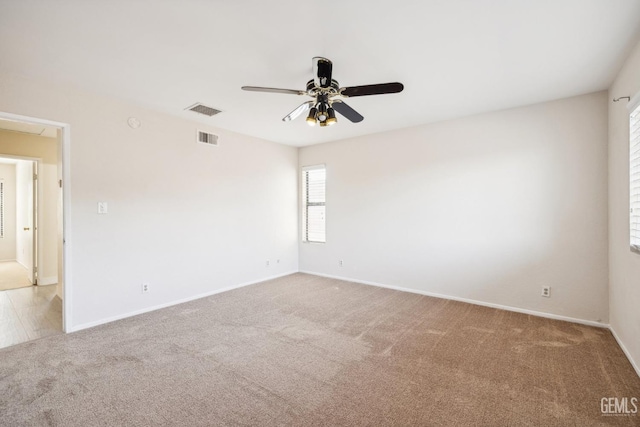 carpeted empty room featuring ceiling fan