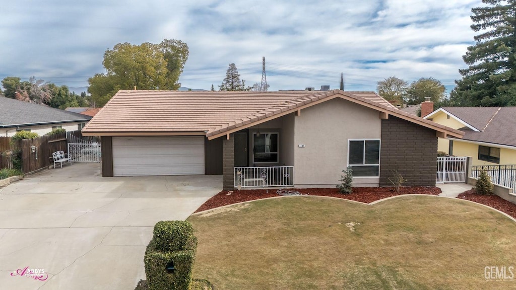 single story home with a garage and a front lawn