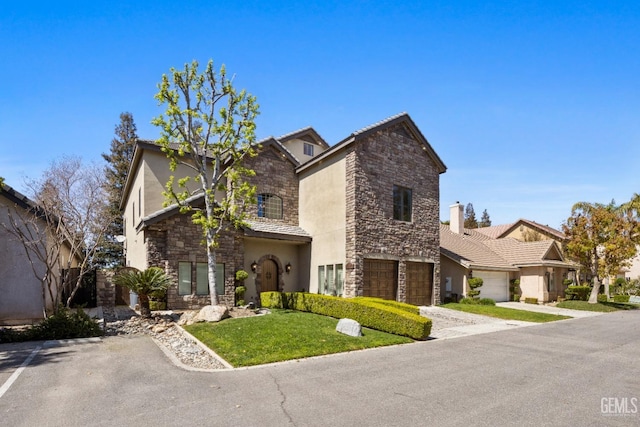 view of front facade featuring driveway, stone siding, stucco siding, a front lawn, and a garage