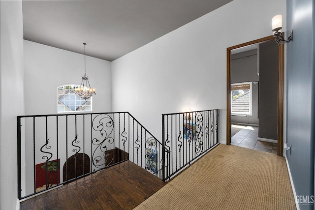 stairs featuring carpet floors and a chandelier