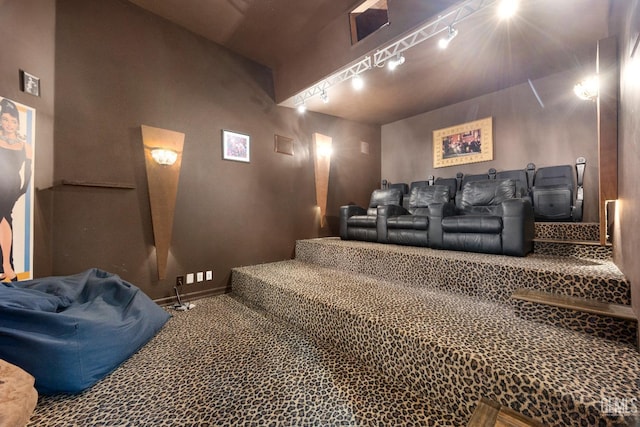 home theater featuring carpet floors and track lighting