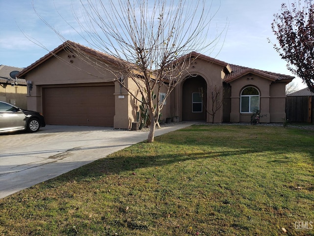 view of front of home with a garage and a front lawn