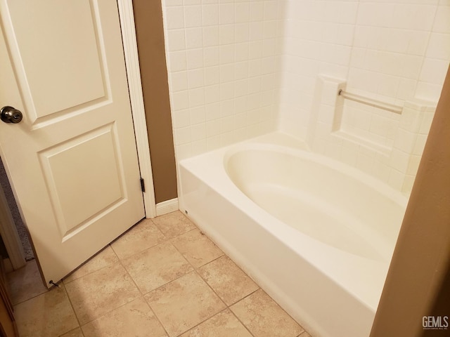 bathroom featuring tile patterned floors and a washtub