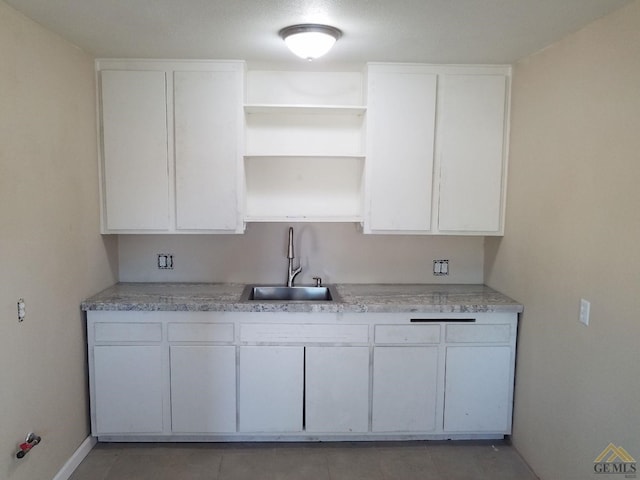 kitchen featuring sink and white cabinets