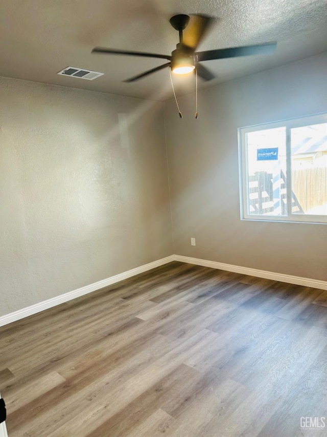 unfurnished room with ceiling fan and light hardwood / wood-style floors