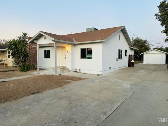 view of front facade featuring a garage and an outbuilding