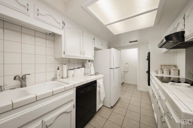 kitchen featuring dishwasher, light tile patterned floors, tile countertops, and white cabinets